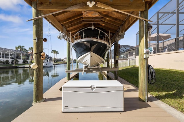 dock area with a lanai, a water view, and boat lift