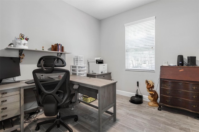 office area with baseboards and wood finished floors