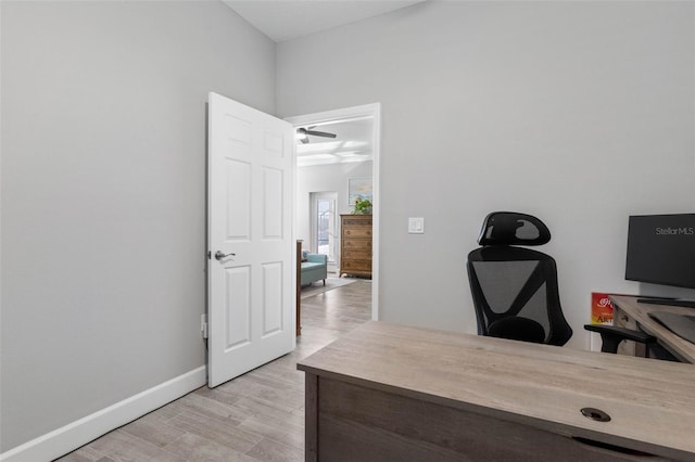 home office featuring light wood finished floors and baseboards