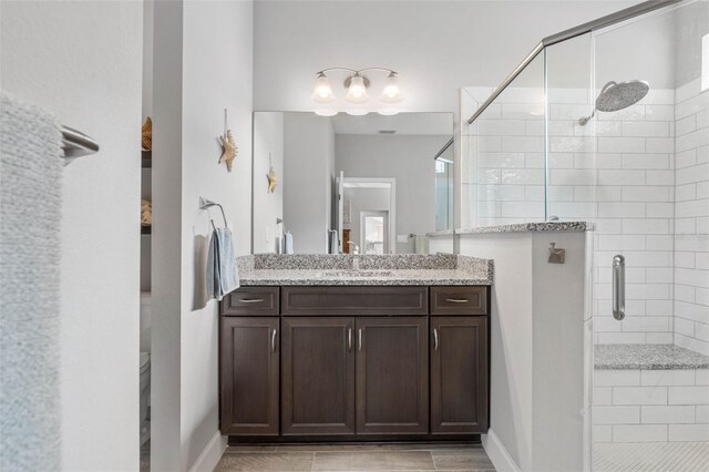 bathroom with a shower stall and vanity