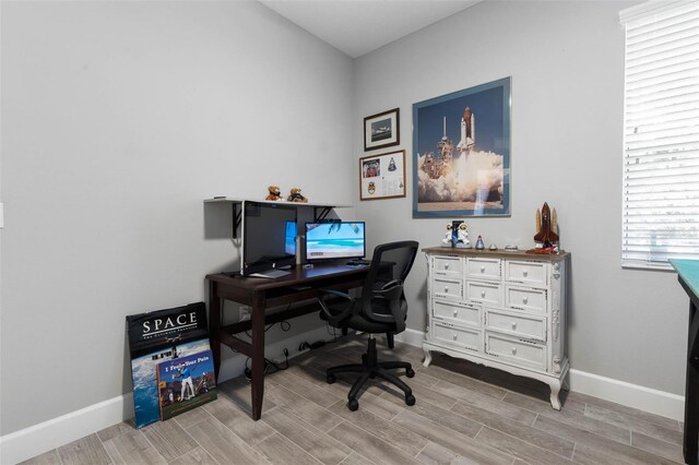 office with baseboards and wood tiled floor