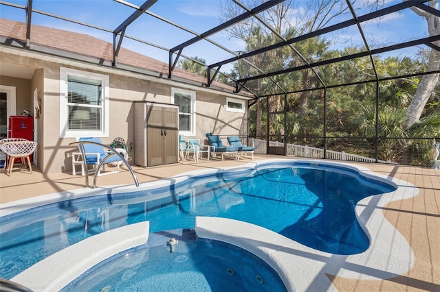 view of swimming pool featuring a pool with connected hot tub, a patio, and a lanai