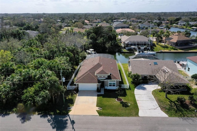 birds eye view of property with a residential view and a water view