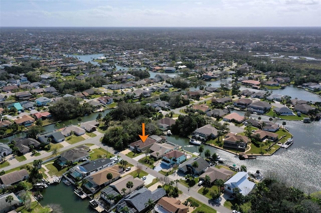 birds eye view of property featuring a water view and a residential view