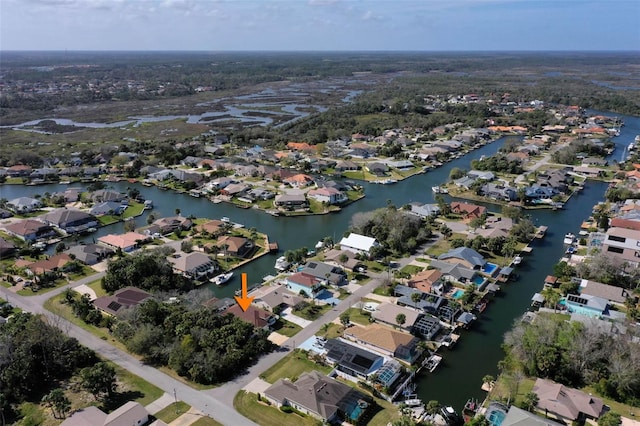 birds eye view of property with a residential view and a water view