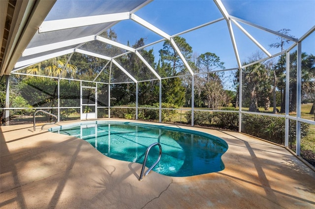 outdoor pool with a patio and glass enclosure