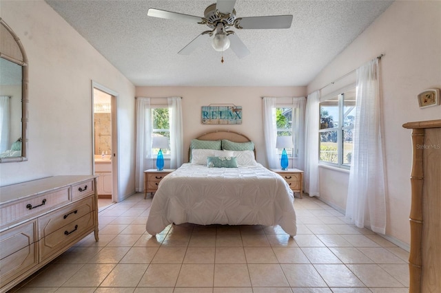 bedroom with connected bathroom, ceiling fan, a textured ceiling, and light tile patterned floors