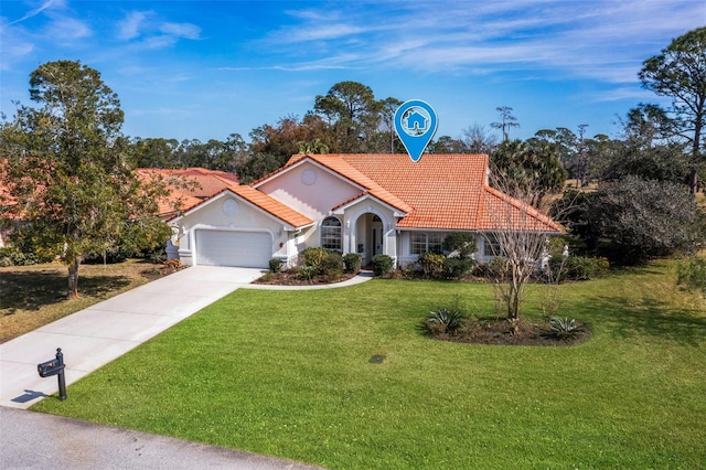 mediterranean / spanish home with an attached garage, a tile roof, concrete driveway, and a front yard