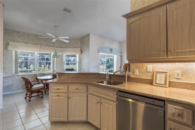 kitchen featuring light stone counters, visible vents, a sink, a textured ceiling, and dishwasher