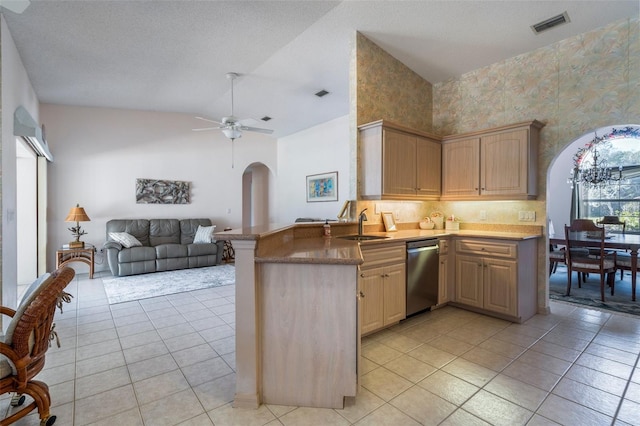 kitchen with visible vents, arched walkways, dishwasher, open floor plan, and a sink