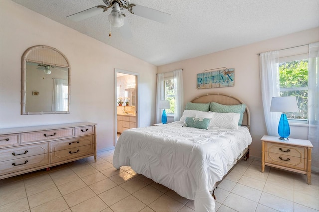 bedroom with lofted ceiling, multiple windows, a textured ceiling, and light tile patterned floors