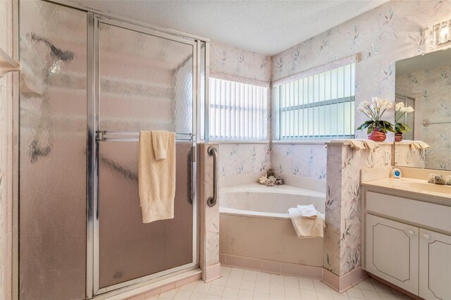 full bath featuring a shower stall, a textured ceiling, vanity, and wallpapered walls