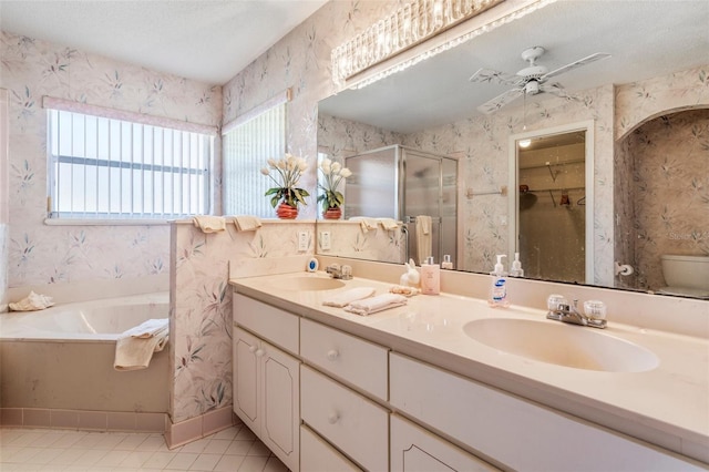 full bath featuring a stall shower, a sink, and wallpapered walls