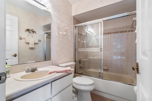 full bathroom with toilet, enclosed tub / shower combo, vanity, and wallpapered walls