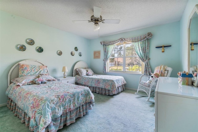 carpeted bedroom featuring a ceiling fan, a textured ceiling, and baseboards