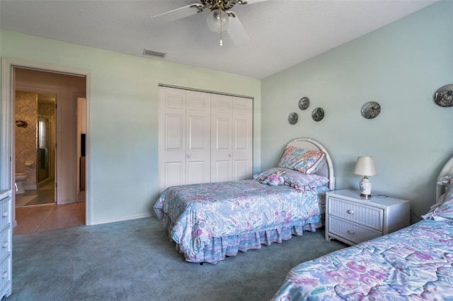 carpeted bedroom featuring a closet, visible vents, a ceiling fan, a textured ceiling, and tile patterned flooring