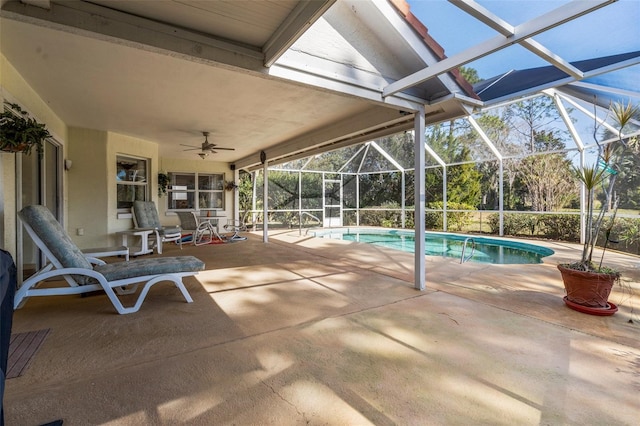 pool with a patio, a lanai, and a ceiling fan