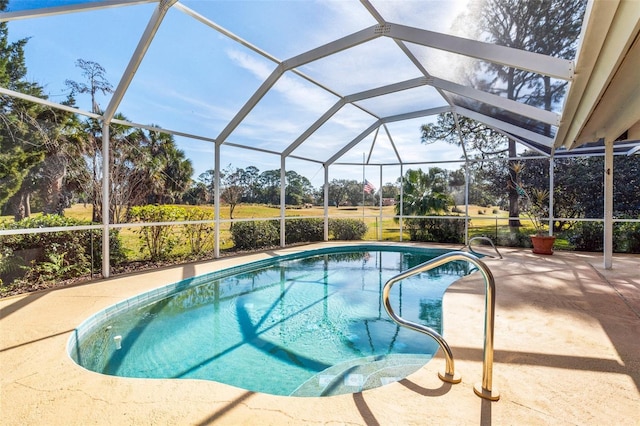 outdoor pool with glass enclosure and a patio area