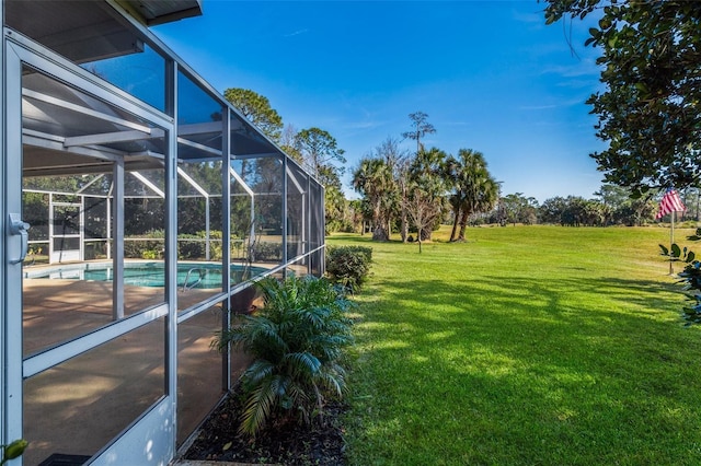 view of yard with glass enclosure and an outdoor pool