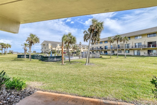 view of home's community featuring a lawn and a residential view