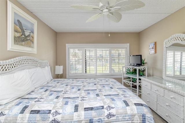 bedroom with ceiling fan and a textured ceiling