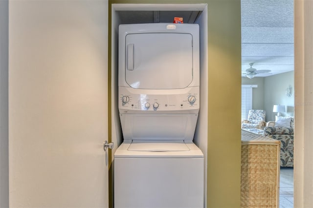 washroom with laundry area, a ceiling fan, and stacked washer and clothes dryer