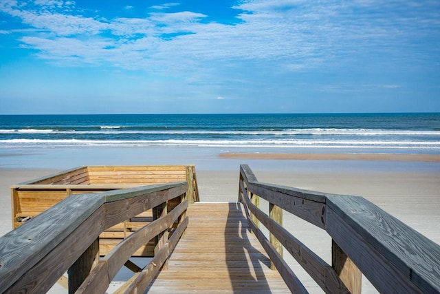 surrounding community with a beach view and a water view