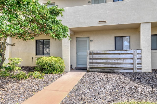 doorway to property with stucco siding