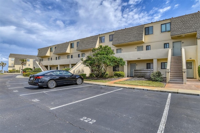 uncovered parking lot with a residential view and stairway