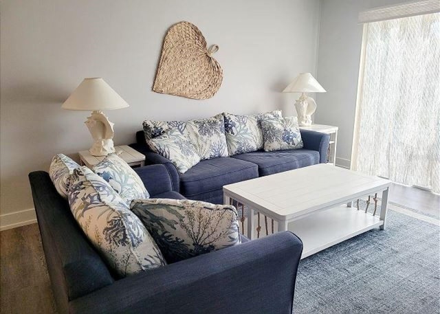 living area featuring baseboards and wood finished floors