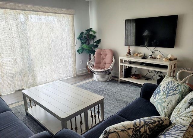 living room featuring baseboards and wood finished floors