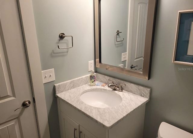 bathroom featuring vanity and toilet