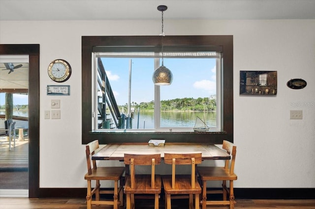 dining room with breakfast area, baseboards, and wood finished floors