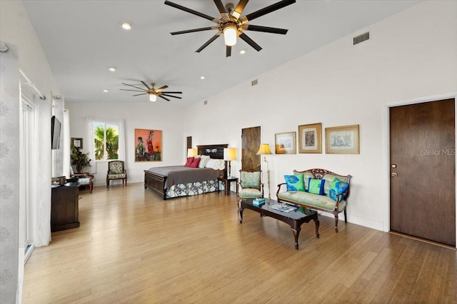 bedroom featuring high vaulted ceiling, recessed lighting, visible vents, and light wood-style flooring