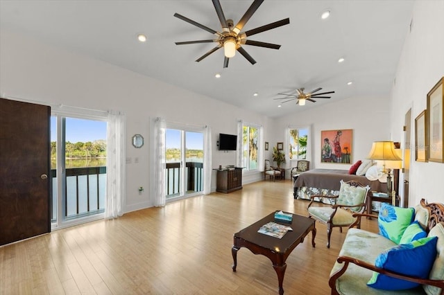 living room featuring lofted ceiling, wood finished floors, a ceiling fan, and recessed lighting