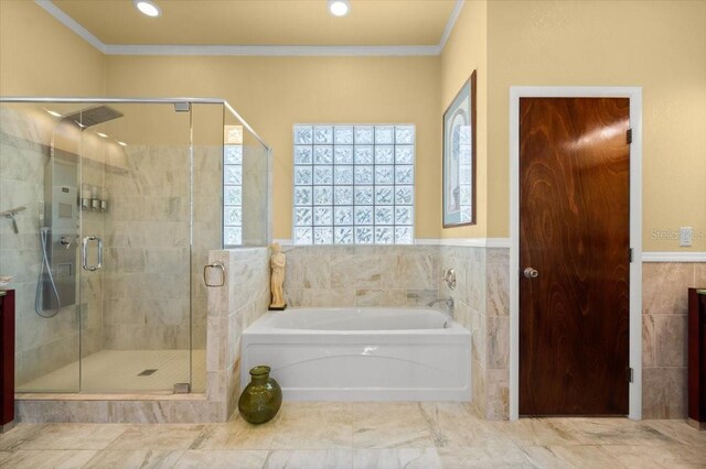 bathroom with ornamental molding, a shower stall, a bath, and tile walls