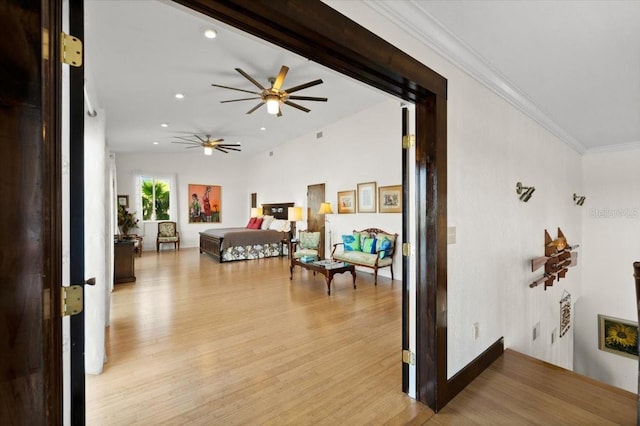 interior space featuring recessed lighting, light wood-type flooring, and crown molding