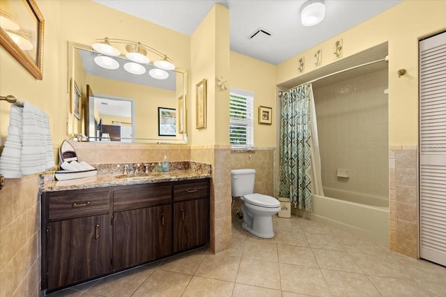 full bath featuring visible vents, toilet, shower / tub combo with curtain, tile patterned floors, and tile walls