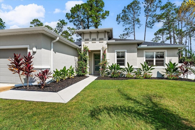 view of front of house with a garage, a front yard, and stucco siding