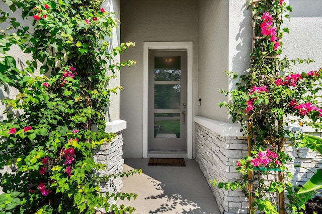 doorway to property with stucco siding