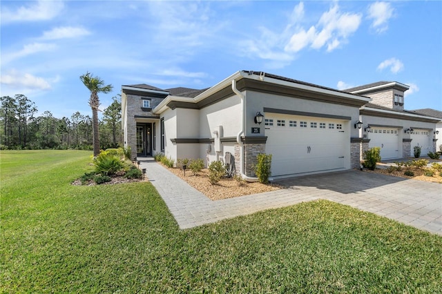 view of front of house featuring stone siding, decorative driveway, an attached garage, and stucco siding