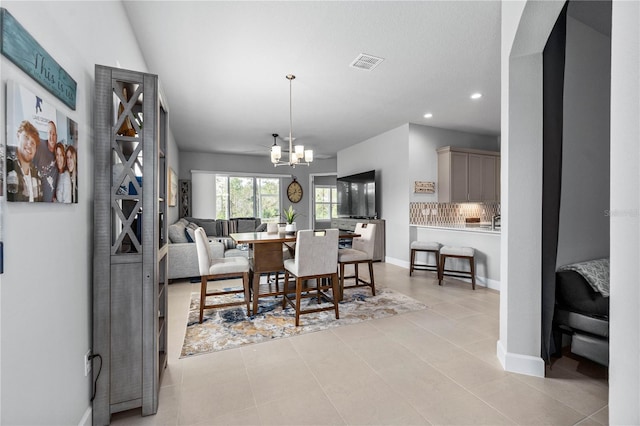 dining space featuring a notable chandelier, recessed lighting, visible vents, light tile patterned flooring, and baseboards