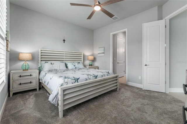 carpeted bedroom featuring a ceiling fan, visible vents, and baseboards