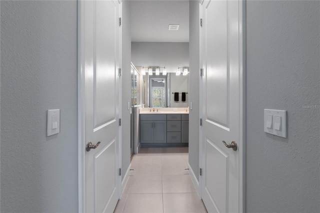 bathroom featuring tile patterned flooring and vanity