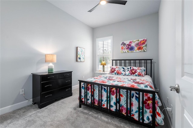 carpeted bedroom with lofted ceiling, ceiling fan, and baseboards