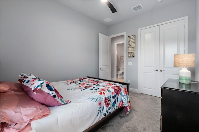 bedroom featuring ceiling fan, light colored carpet, visible vents, baseboards, and a closet