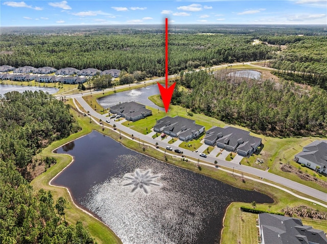 birds eye view of property featuring a water view, a residential view, and a view of trees