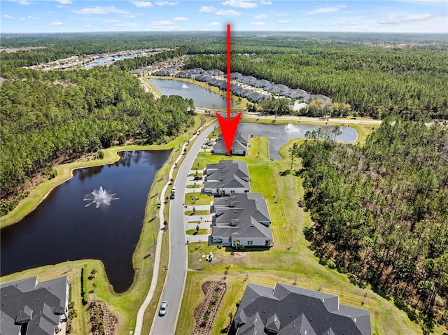 aerial view with a water view and a forest view