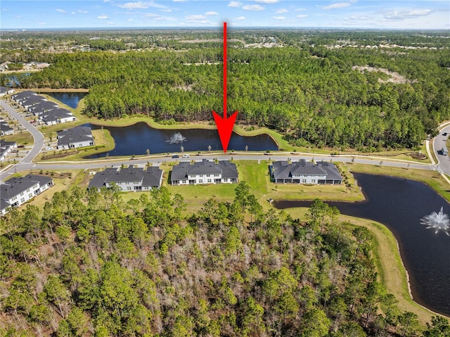 bird's eye view with a water view, a residential view, and a view of trees