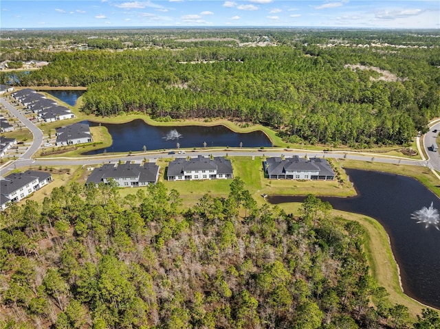 bird's eye view featuring a water view, a wooded view, and a residential view